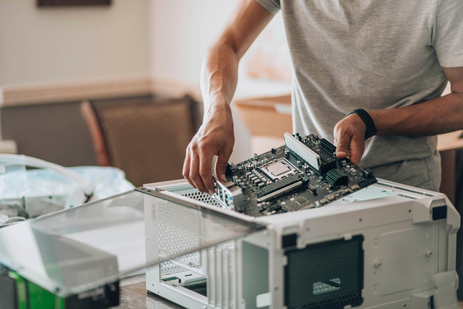 Tech Tactician: Meticulously assembling components, hands guide the central hub of processing power into its chassis, where data will flow and computations will spark.
